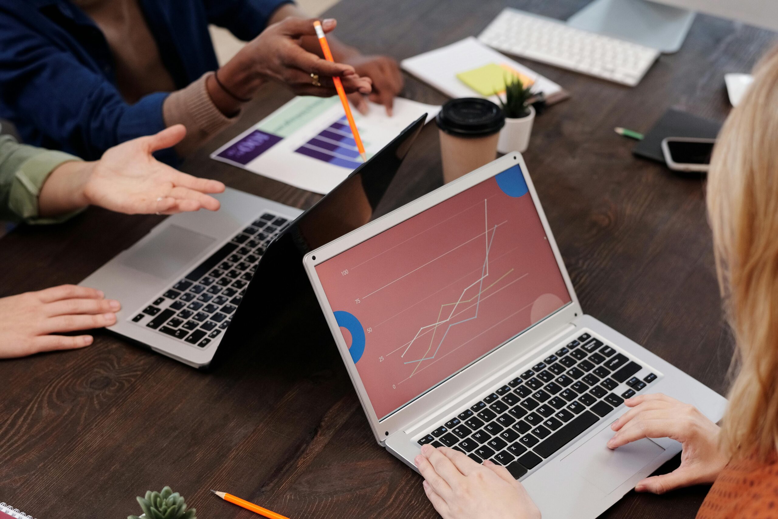 Professionals focused on growth marketing planning and analytics while using laptops.