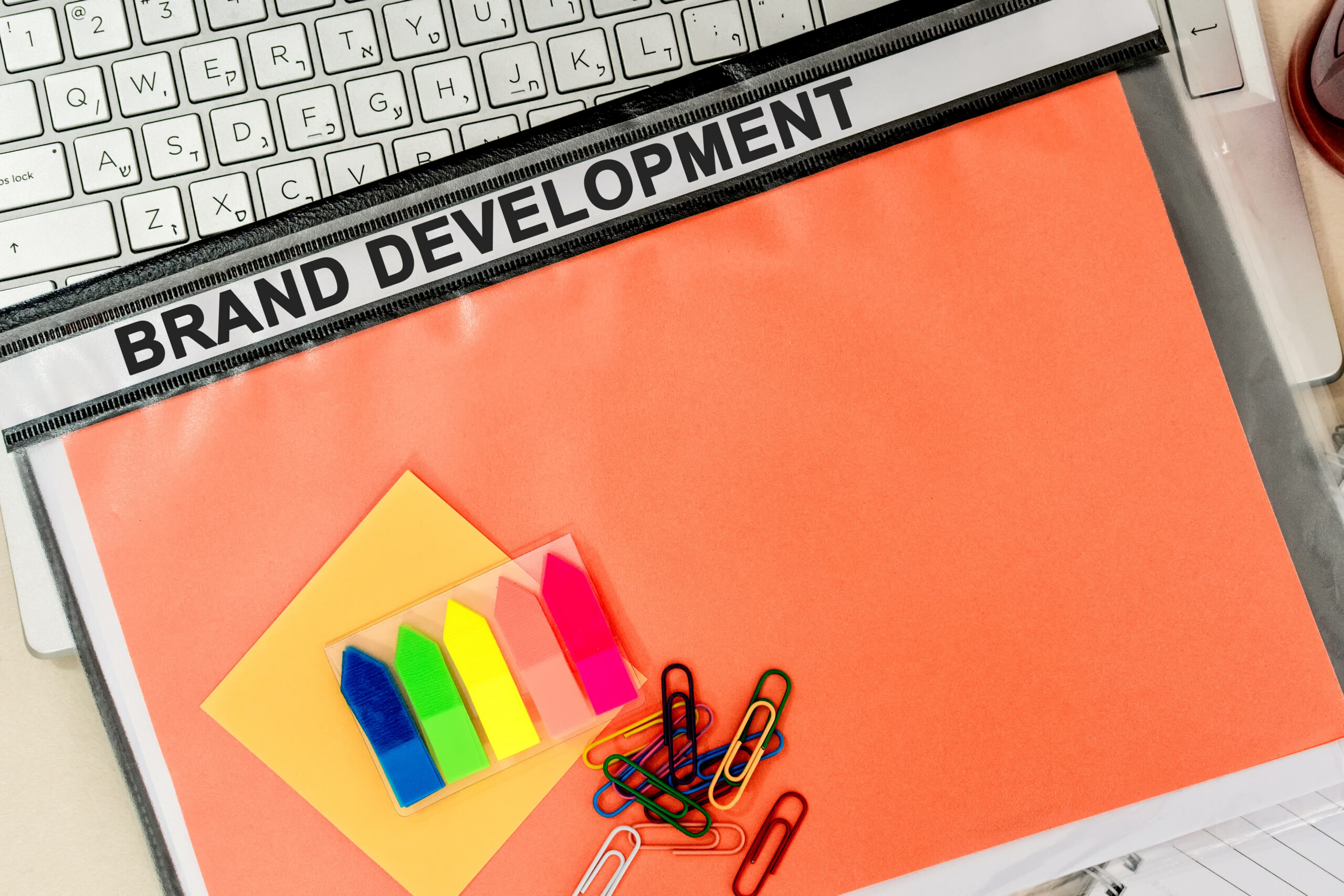 Top view of branding documents on a desk, highlighting the structured approach of strategic brand development.